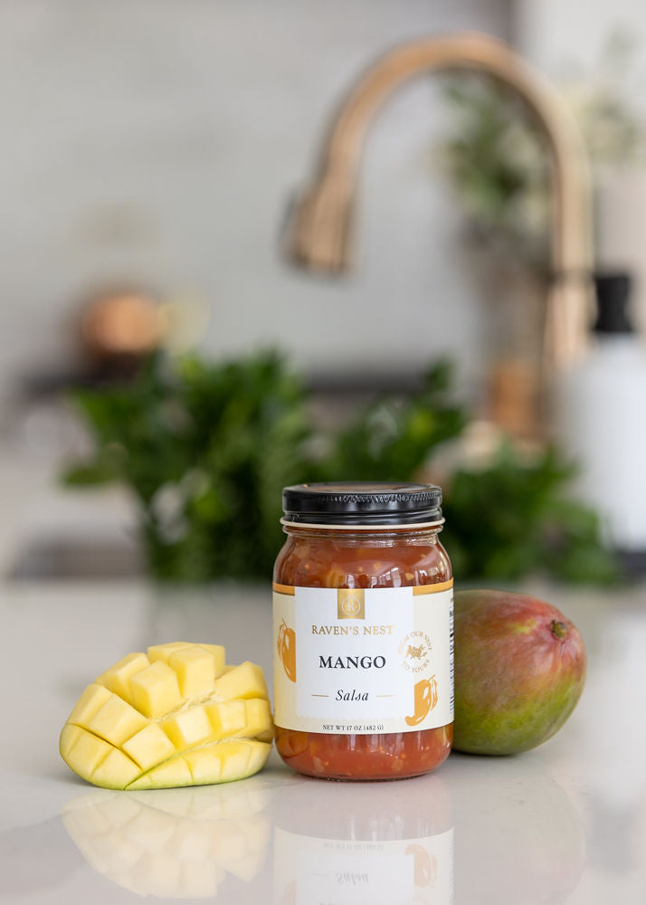 Mango Salsa Jar on Kitchen Counter with Mangos