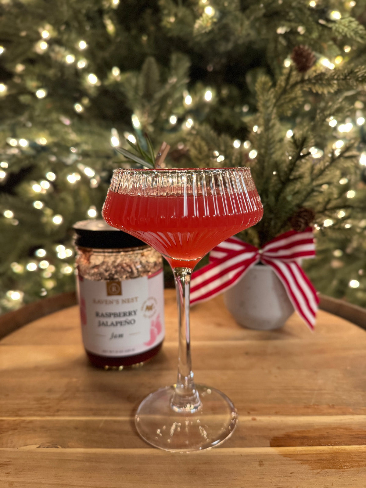Shake up a festive Mrs. Clausmopolitan with Raven’s Nest Raspberry Jalapeño Jam, citron vodka, orange liqueur, cranberry juice, and fresh lime.