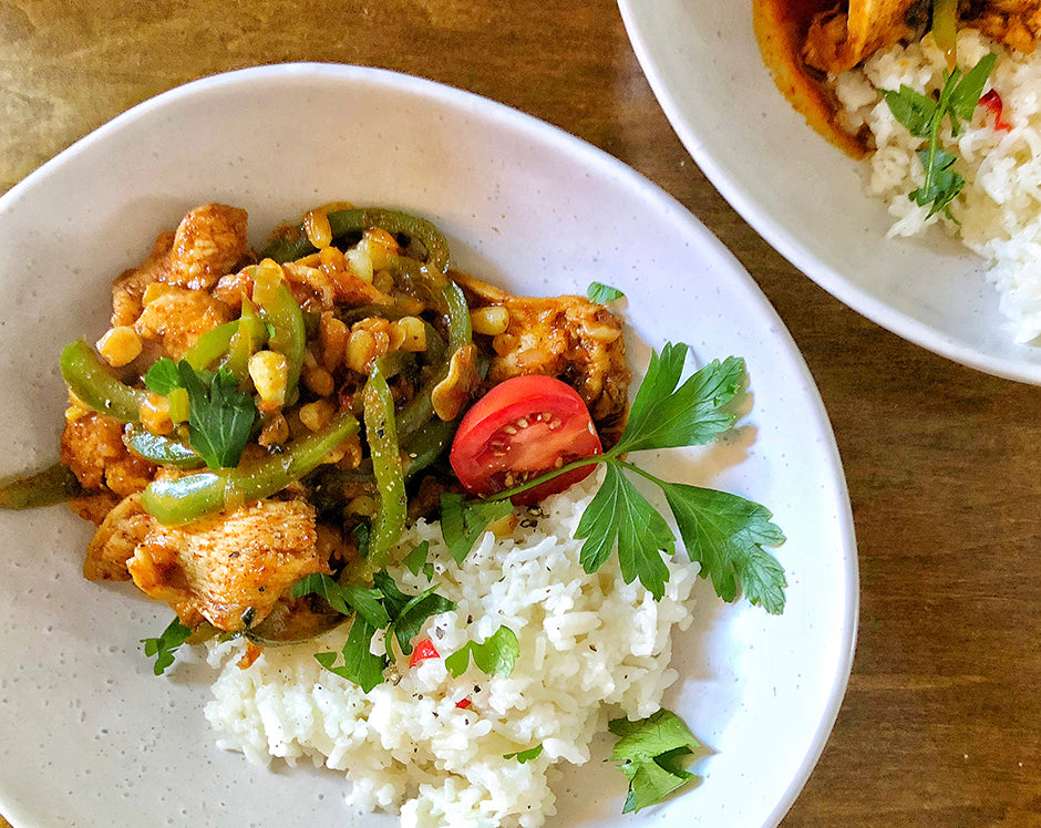 Tex Mex Hot Peach Chicken Served over a bed of rice with green peppers.