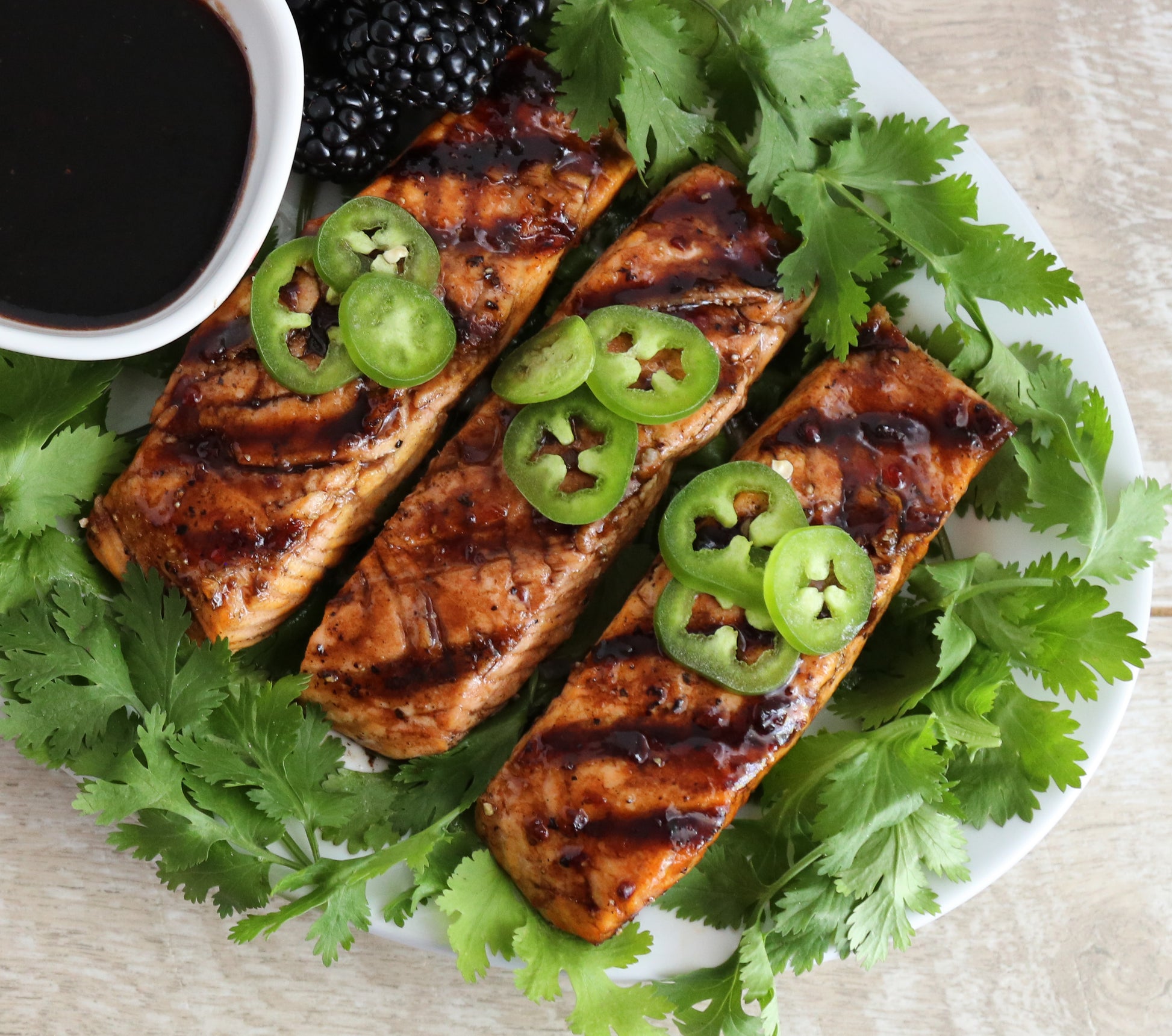 Blackberry Jalapeno Grilled Salon on a bed of greens garnished with Jalapeno Slices