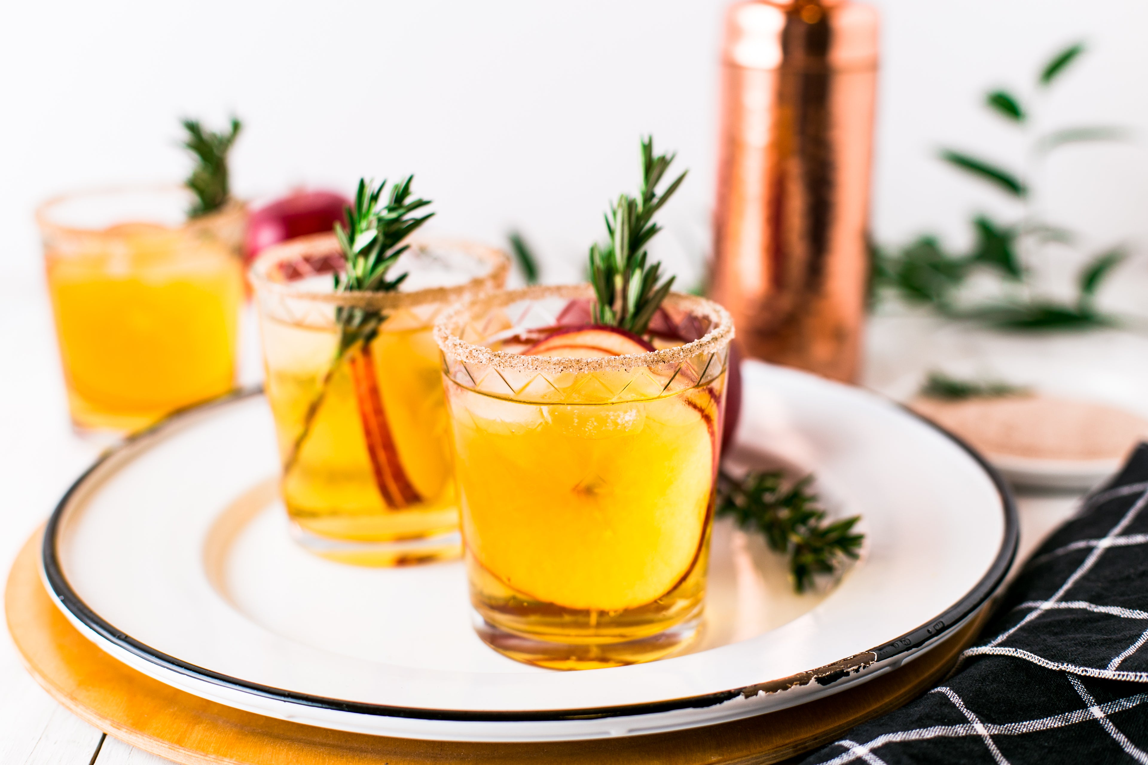 Cocktails with apples and rosemary in a holiday setting