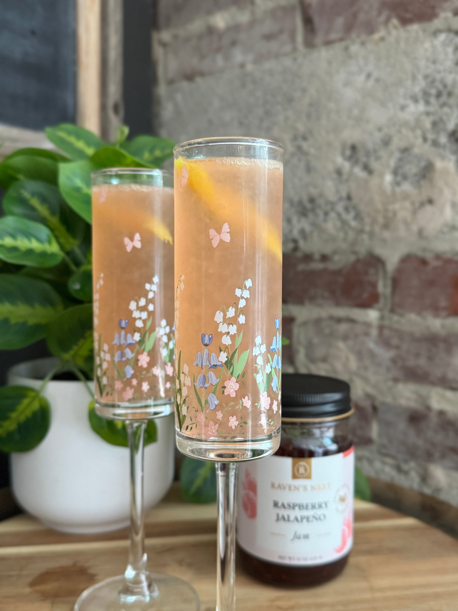 Celebrate with a Mother's Day 75 featuring Raven’s Original Raspberry Jalapeño Jam simple syrup, gin, fresh lemon juice, and sparkling Prosecco.