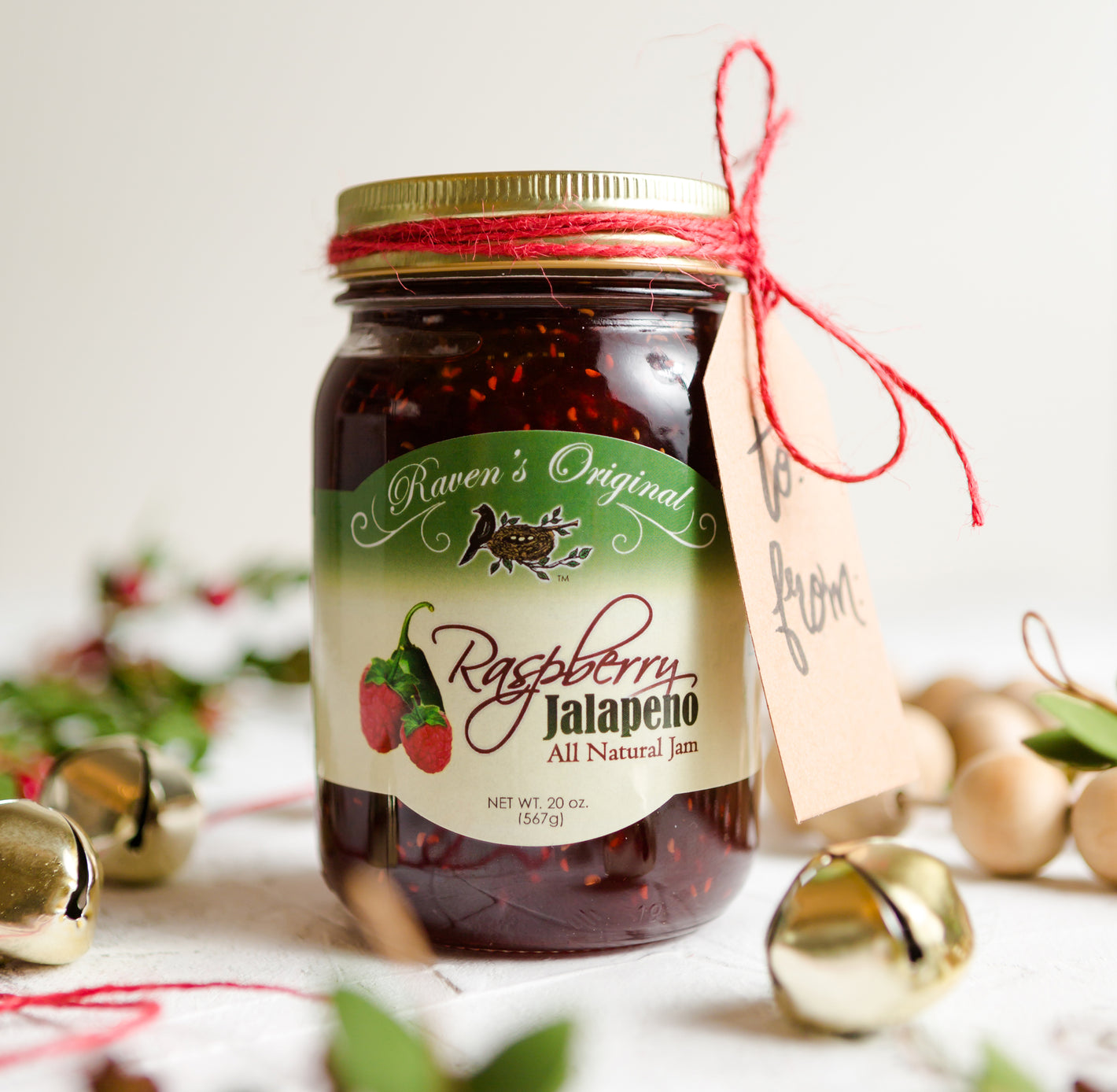 Jam Gifts for Christmas - Raven's Nest Raspberry Jalapeno Jam wrapped with a gift tag for holiday gifting