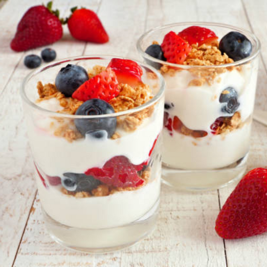 Red White and Blue Yogurt Parfait with layers of vanilla yogurt, Raven's Nest Strawberry Jalapeno Jam, strawberries, blueberries, and granola in individual glass cups