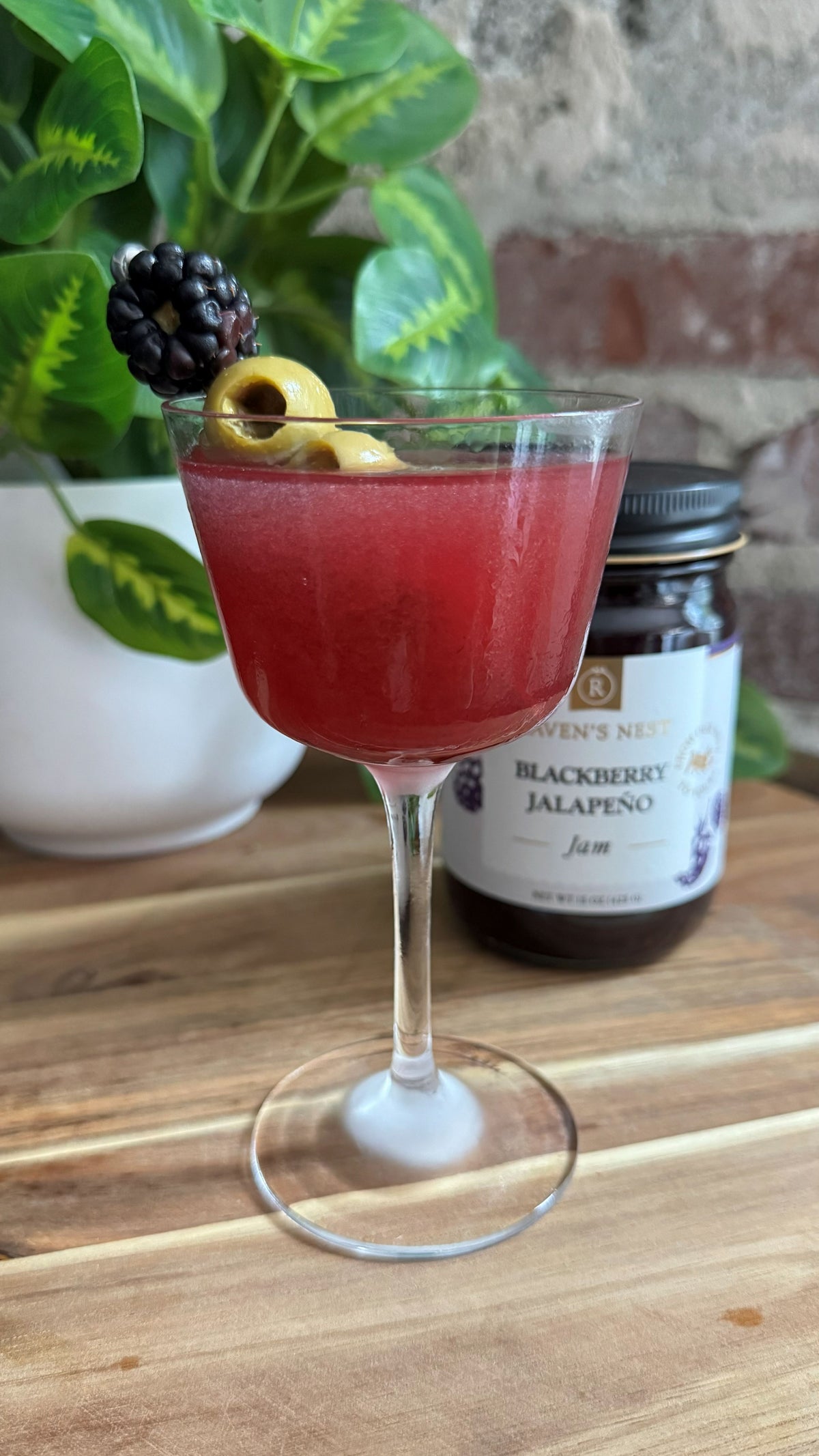 Shake up a Sweet Heat Martini with Raven’s Nest Blackberry Jalapeño Jam, gin or vodka, and jalapeño-stuffed olive brine for a bold sweet-and-spicy cocktail.