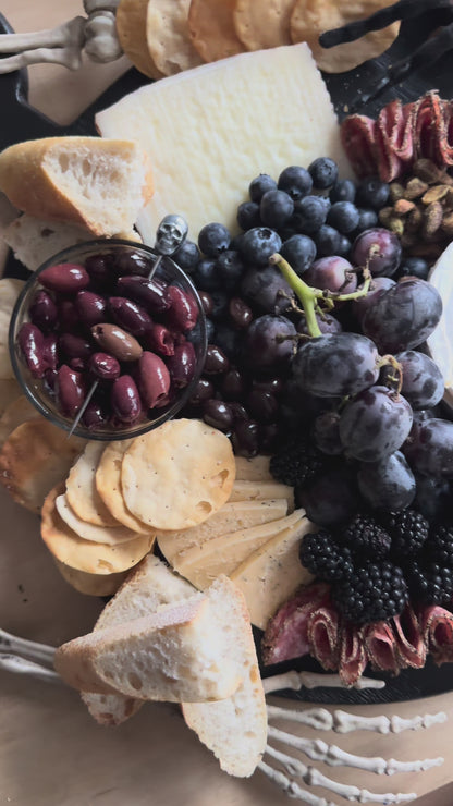 Create a Halloween Spook-cuterie Board with Raven’s Nest Blackberry Jalapeño Jam, cheeses, cured meats, fresh berries, chocolate treats, and spooky seasonal extras.