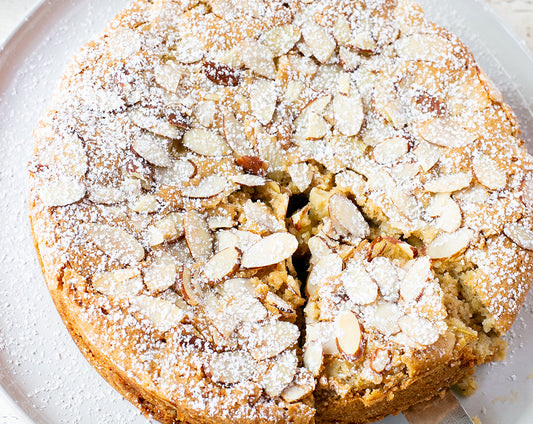 Pear coffee cake made with Raven's Mulling Spice and cinnamon pear jam, topped with almonds and powdered sugar
