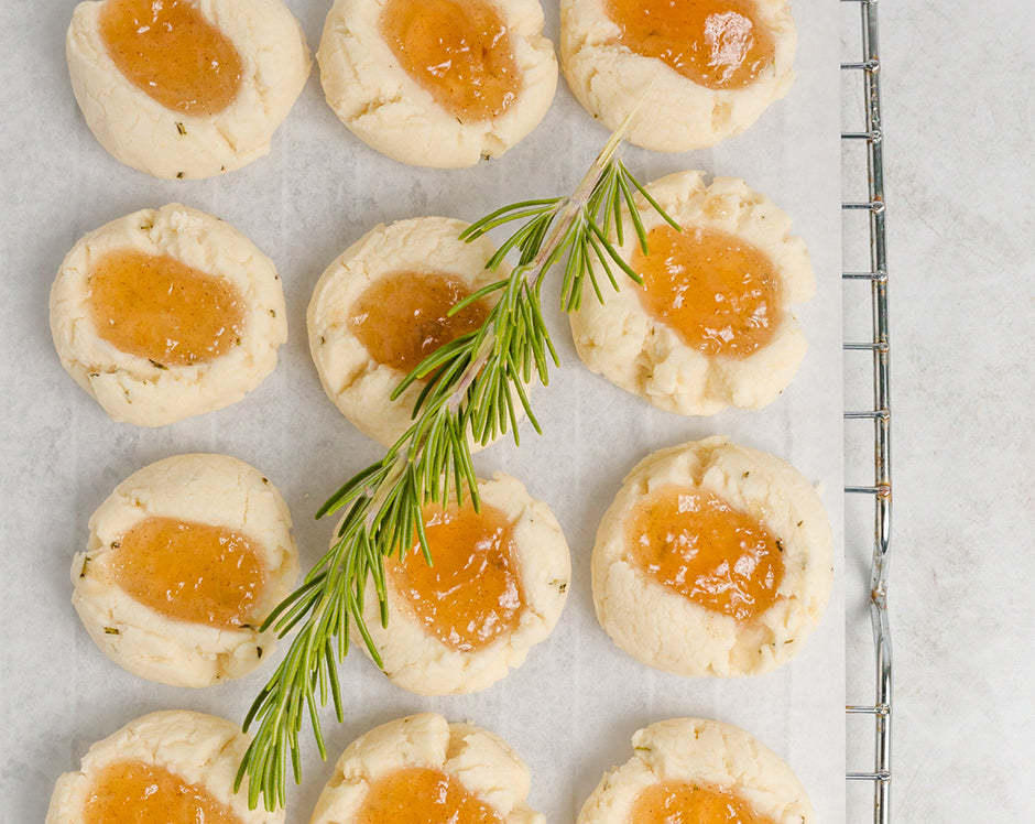 Shortbread thumbprint cookies filled with Raven's Nest Cinnamon Pear jam and garnished with rosemary