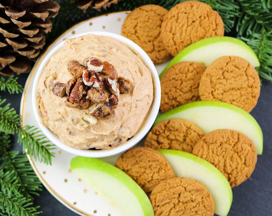Pumpkin butter dip fall party appetizer made with Raven's Nest mulling spice and cream cheese, served with gingersnap cookies and granny smith apples and topped with pecans
