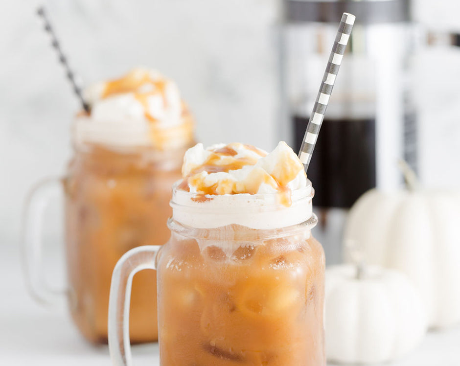 Pumpkin cold brew made with Raven's Nest pumpkin butter and coffee, topped with fresh whipped cream and caramel sauce