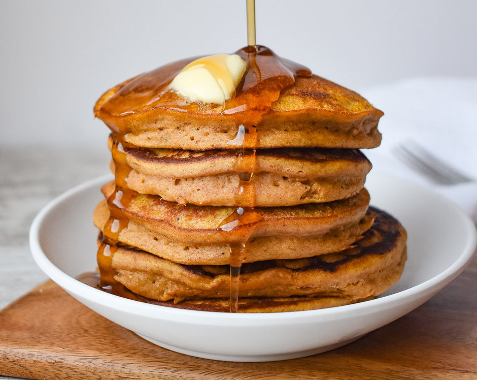 Stack of pumpkin pancakes topped with butter and mulling spice syrup, made with Raven's Nest pumpkin butter
