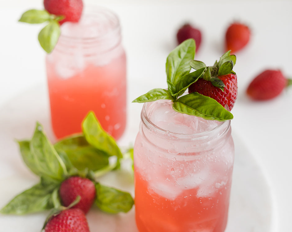 Strawberry basil spritzer cocktail made with cocktail simple syrup made from jam, Raven's Nest strawberry jalapeno jam garnished with fresh basil and strawberries