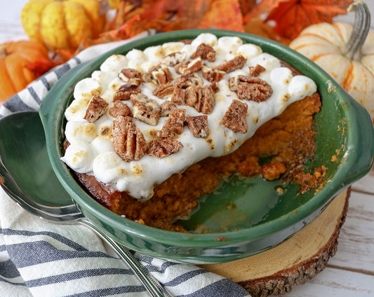 Sweet potato casserole recipe with crunchy pecan topping and marshmallows, seasoned with Raven's Nest mulling spice and surrounded by fall Thanksgiving foliage